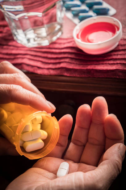 istock Women take white capsule with left hand 694354154