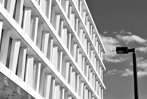 istock Modern building. Modern office building with facade of glass. Black and white 694357320