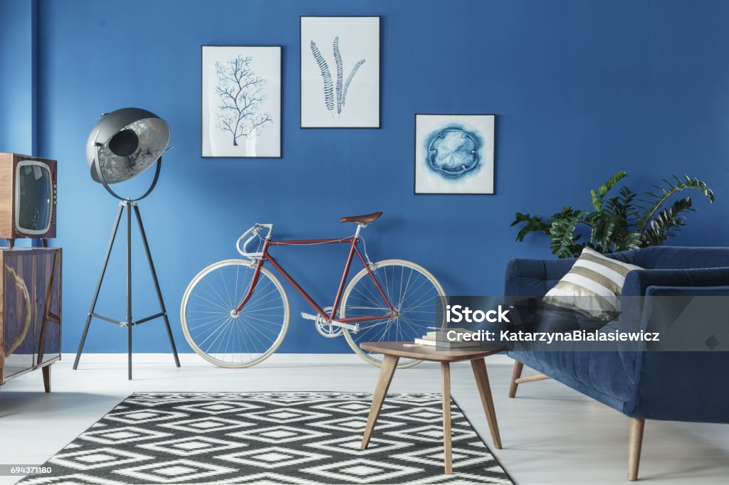 Cozy loft interior Cozy blue and white loft interior with sofa and bicycle Blue Stock Photo
