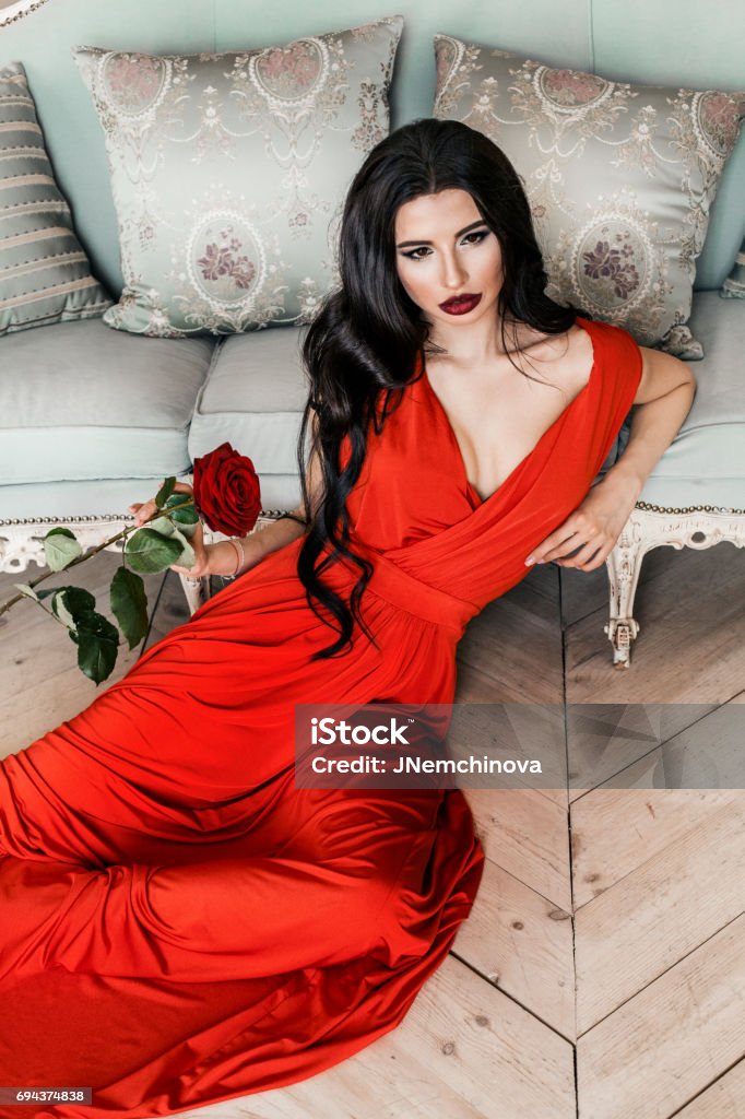 Modelo Hermosa Mujer Con Largo Cabello Negro Y Maquillaje Con Vestido Rojo  Foto de stock y más banco de imágenes de Mujeres - iStock