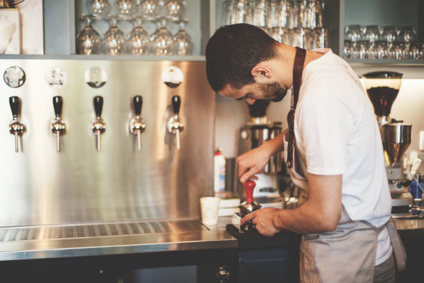 istock Barista working in coffee shop 694375520