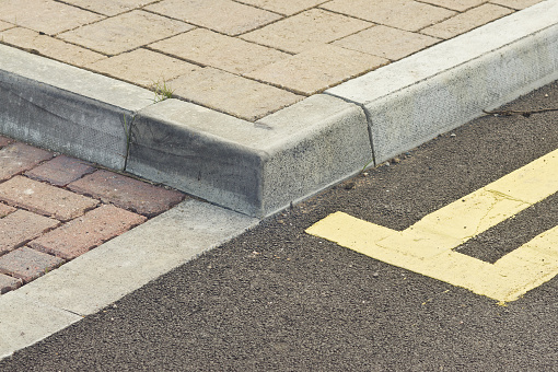 Tiled walkway in England, with double-yellow lines