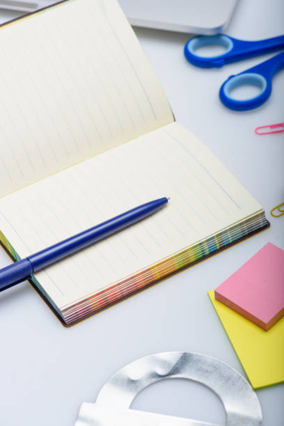 istock empty copybook and different school supplies isolated on white 694375650