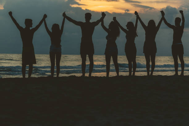 istock Summer vacation with friends: beach party at sunset 694382234