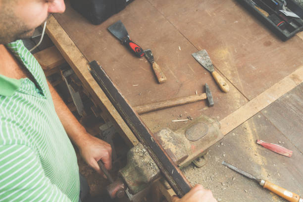 istock Carpenter working on the raw board / wood. 694382736