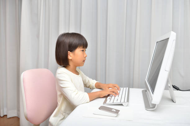 Girl operating computer stock photo