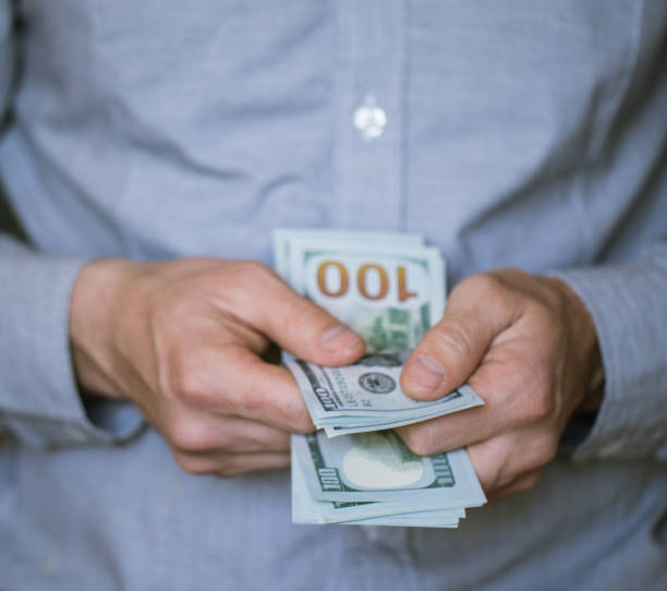 istock Businessman holding money in his hands 694389086