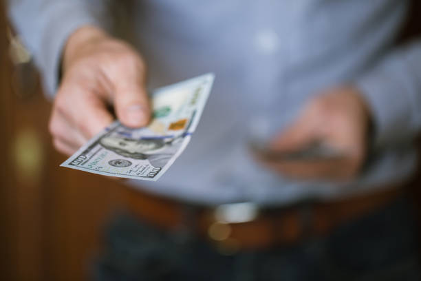 istock Businessman holding money in his hands 694389124