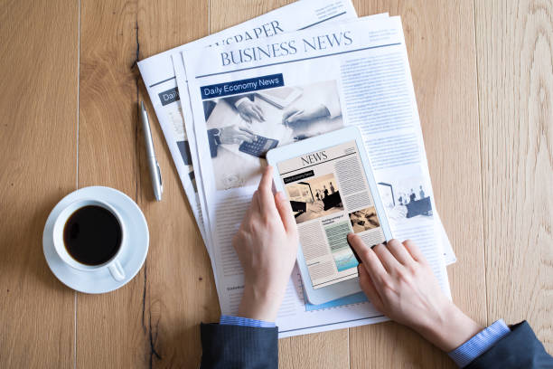 istock Newspaper on wooden table 694389334