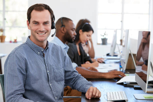 istock Man and woman with documents in an office, smiling, close up 694389724