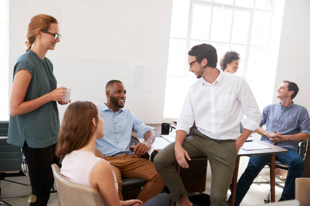 istock Man and woman with documents in an office, smiling, close up 694389858