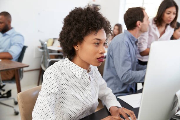 istock Man and woman with documents in an office, smiling, close up 694389874