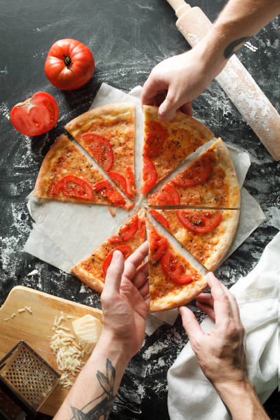 istock Delicious pizza with tomato on dark background 694390292