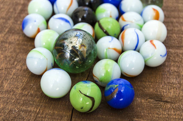 istock Children's games, playing marbles, various colored marble paintings, 694402098