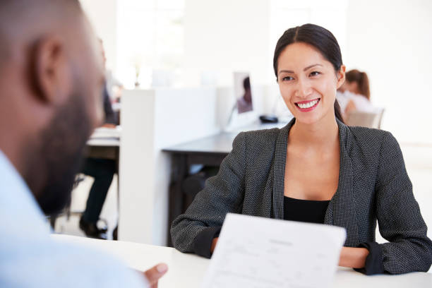 istock Man and woman with documents in an office, smiling, close up 694402242
