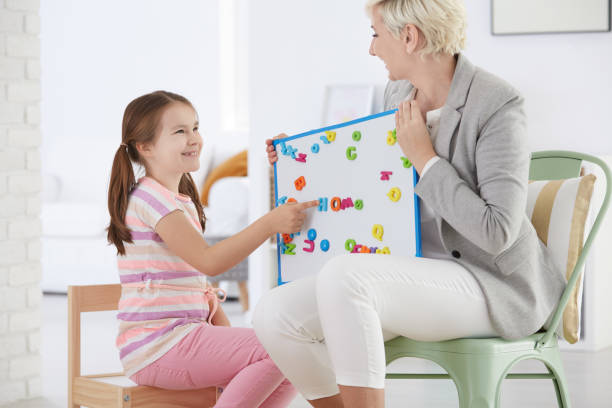 istock Woman holding whiteboard with letters 694402956
