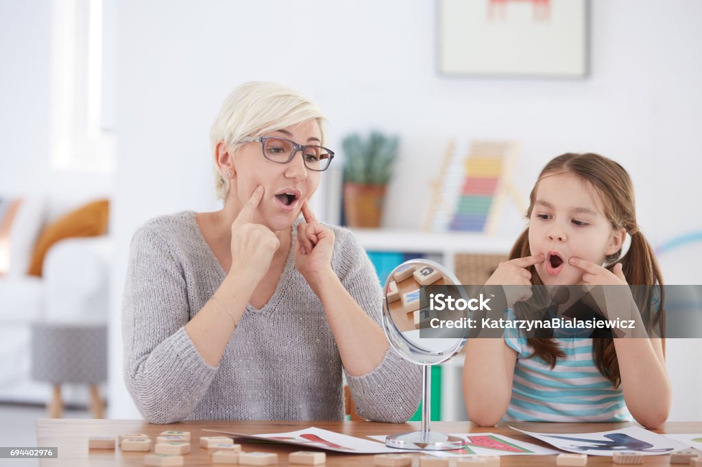 Proper articulation therapy for girl Proper articulation therapy for girl learning to speak Speech Therapy Stock Photo