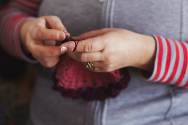 istock Old women crocheting beautiful art-peace 694409268