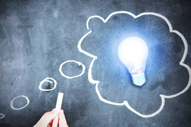 istock New brilliant idea is generated, with light bulb and chalk sketch on blackboard 694409382