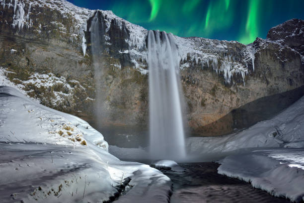 istock Skogafoss Waterfall and Green Aurora, Iceland 694412920