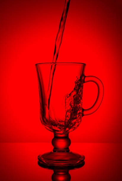 istock Sparkling water. Dynamic spike, thirst quenching on a hot day. Pure water on a red background. 694413310