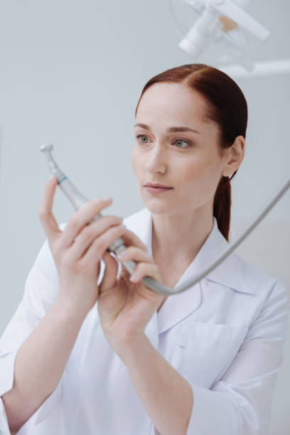 istock Attractive medical worker examining new instrument 694415826