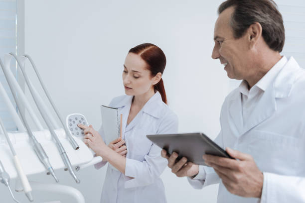 istock Attentive female person putting her forefinger on the control panel 694416428