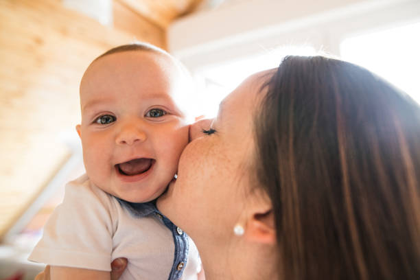 istock Beautiful mother holding her cute baby son 694422112