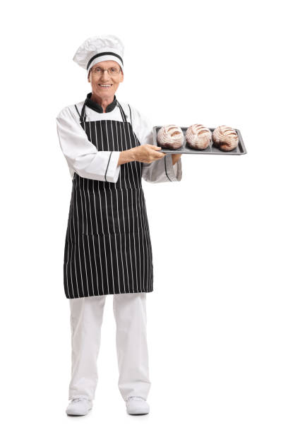 istock Baker holding a tray with loaves of bread 694422506