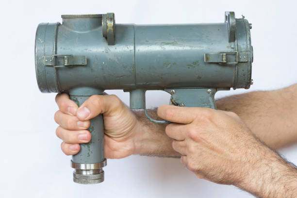 istock Naval vintage signal light gun for communication hold by man 694422586