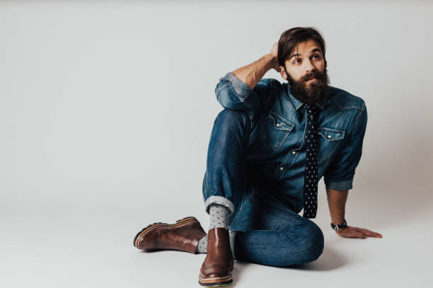 Portrait of confused bearded young man