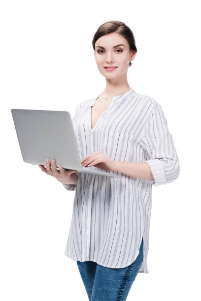 istock young caucasian woman using laptop while standing and looking at camera 694429870