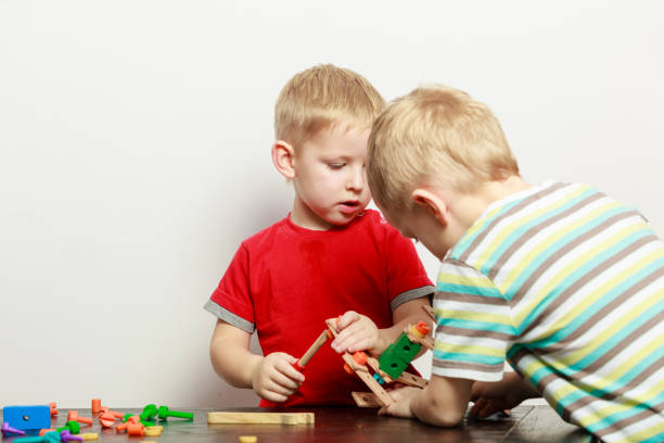 istock Two little boys playing with toys having fun 694433138