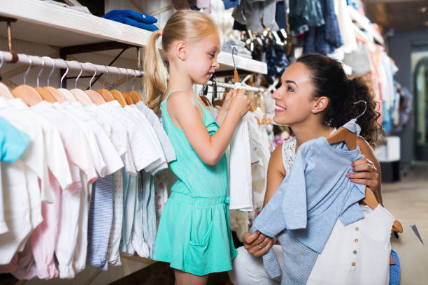 istock Mother with daughter buying clothes 694437994