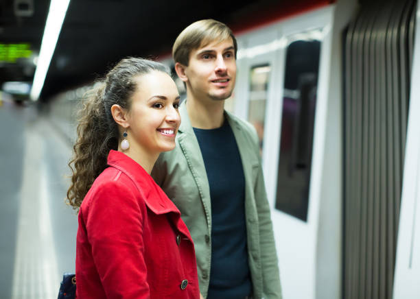istock Positive couple with suitcases waiting for train 694438284