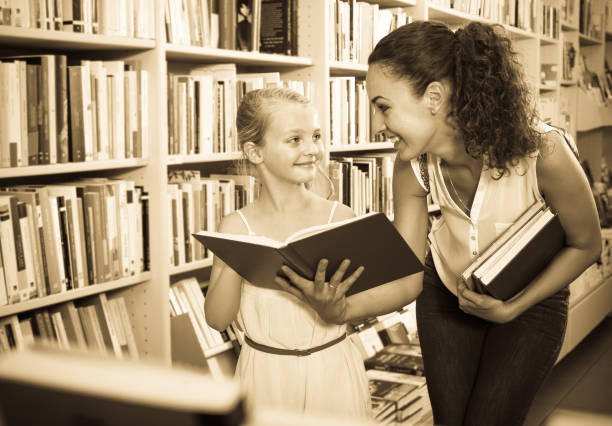 istock Mother with daughter in bookstore 694438560