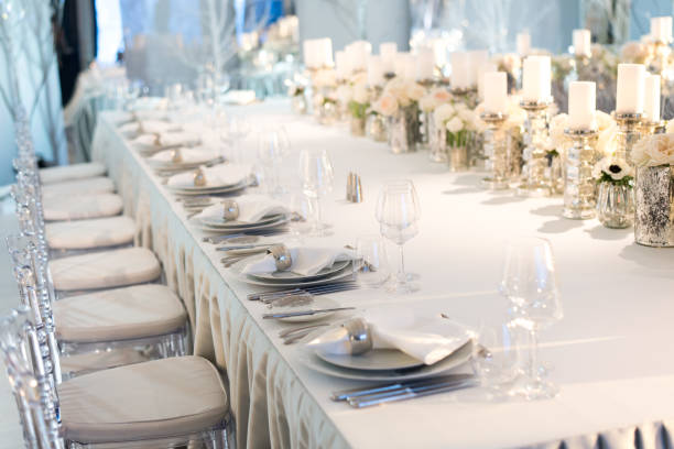 istock Banquet table decor. Candles in vases and flowers 694443650