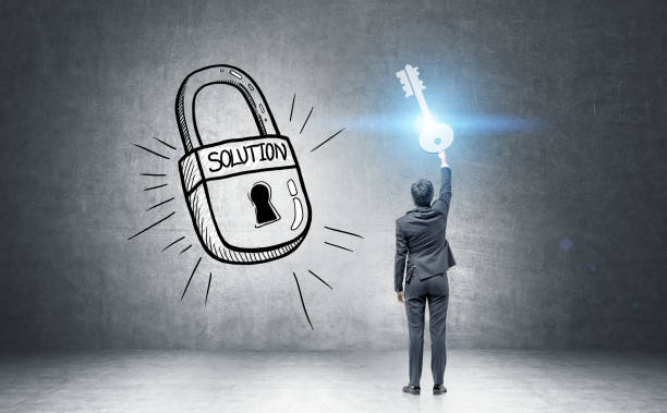 istock Businessman holding a giant key to success 694444426