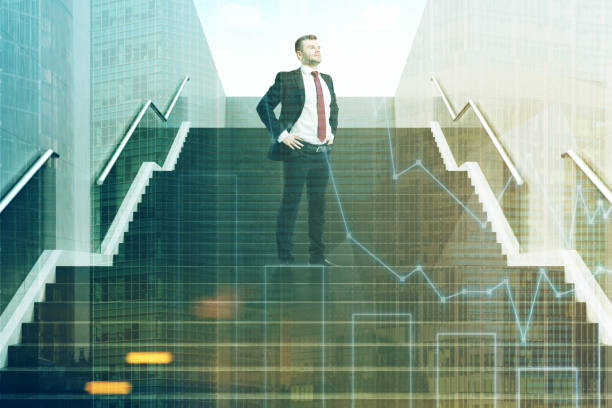 istock Confident businessman on staircase graphs 694447424