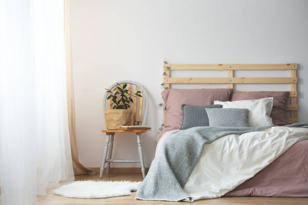 istock Wooden bed in bedroom 694447724