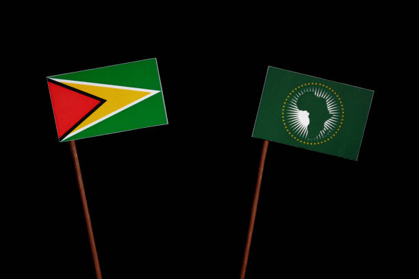 istock Guyana flag with African Union flag isolated on black background 694450462