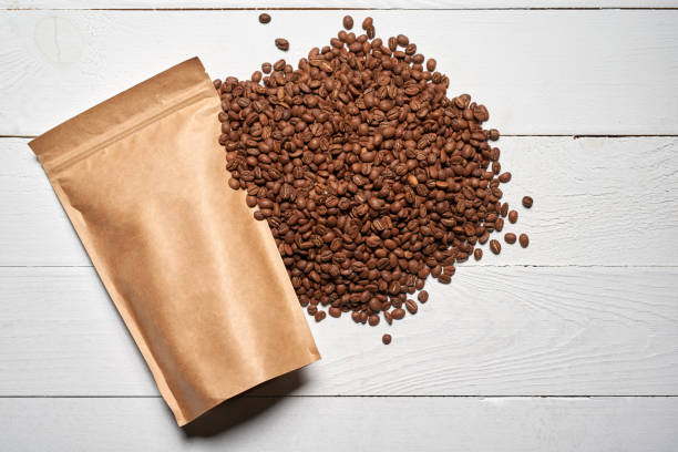 istock Mock-up craft paper pouch bags with coffee beans 694450904