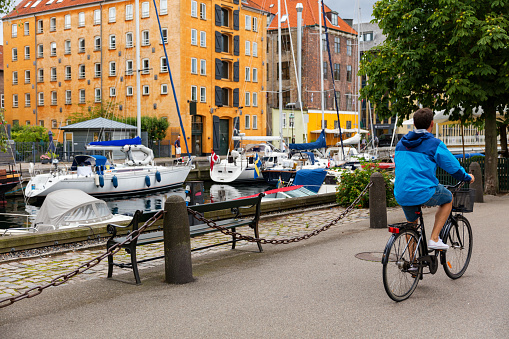 Cyclist on Copenhagen bike lane near canal