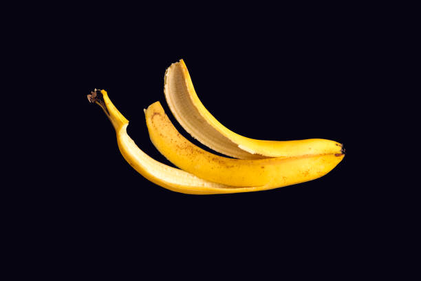 istock Yellow Banana peel isolated on black background 694454738
