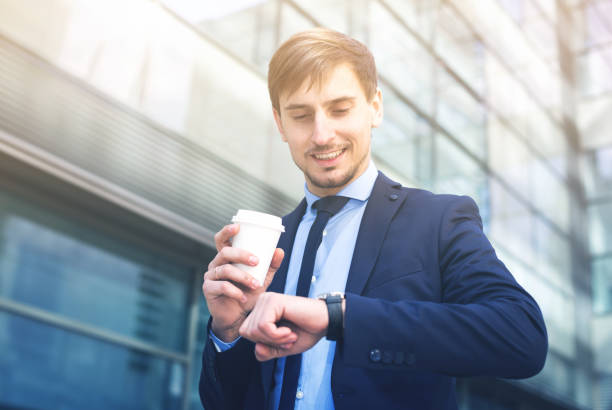 istock Businessman in suit with cup of coffee 694457722