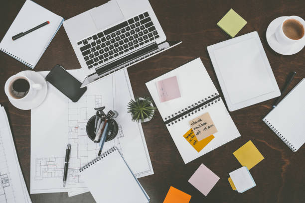 istock flat lay with digital devices, notepads, sticky notes and office supplies on tabletop at workspace 694458542