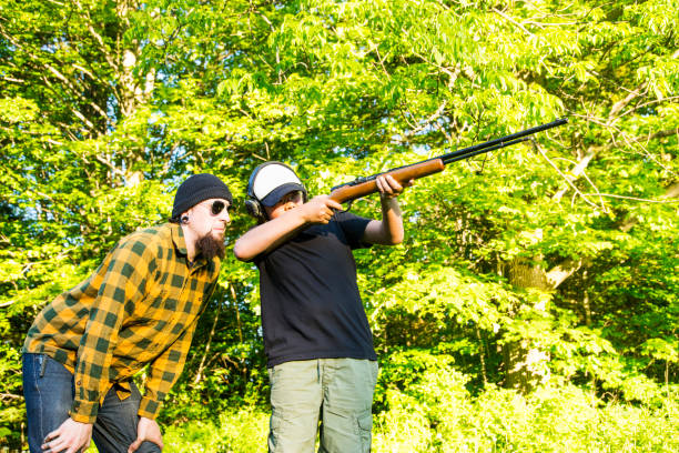 istock Boy being taught how to shoot a rifle safely 694468438