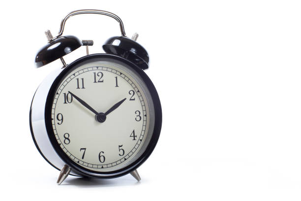 istock Round retro black alarm clock with bells 694474312