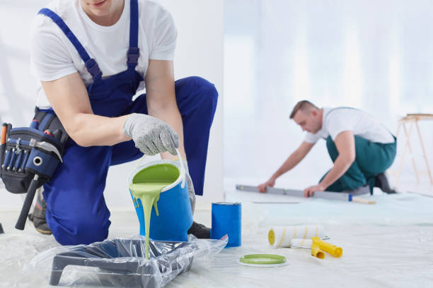 Painting the walls Man painting the walls and spilling the paint house painter stock pictures, royalty-free photos & images