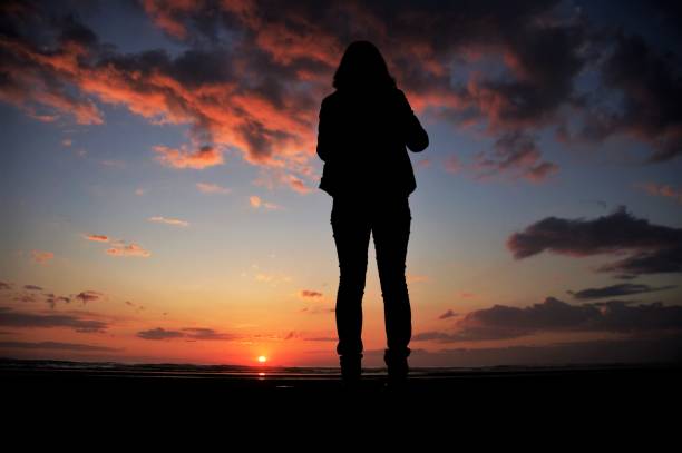 istock Watching the sunset at the beach 694478440
